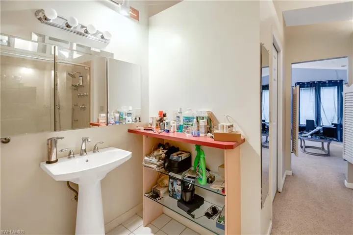 Bathroom with tile flooring and an enclosed shower