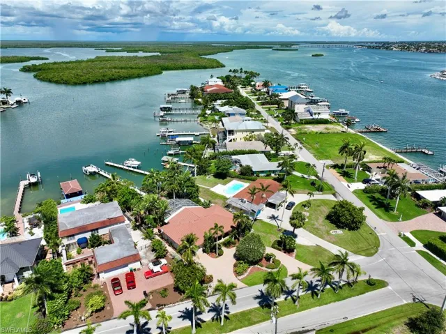 Birds eye view of property with a water view