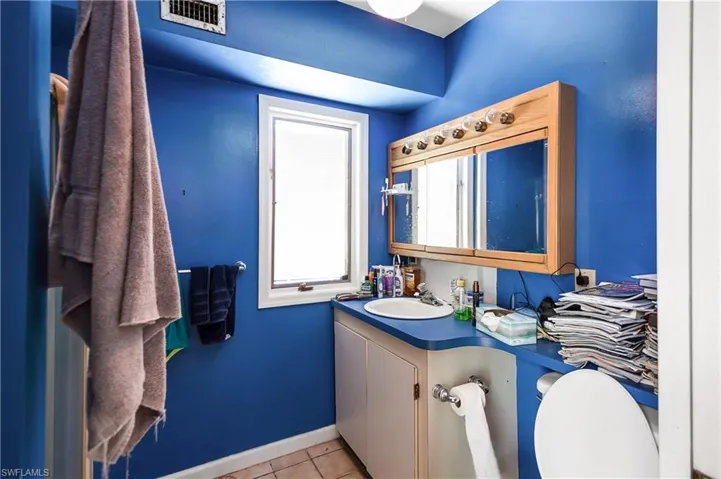 Bathroom with tile flooring, toilet, and vanity