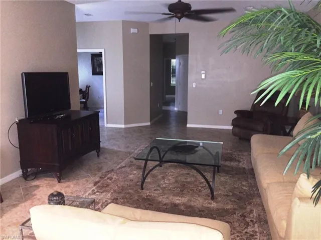 The property features neutral-toned walls, tile flooring, and a ceiling fan