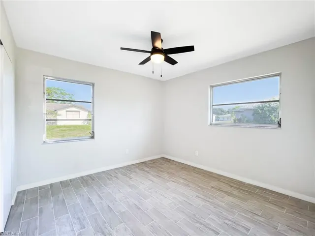 Spare room with ceiling fan and light wood-type flooring