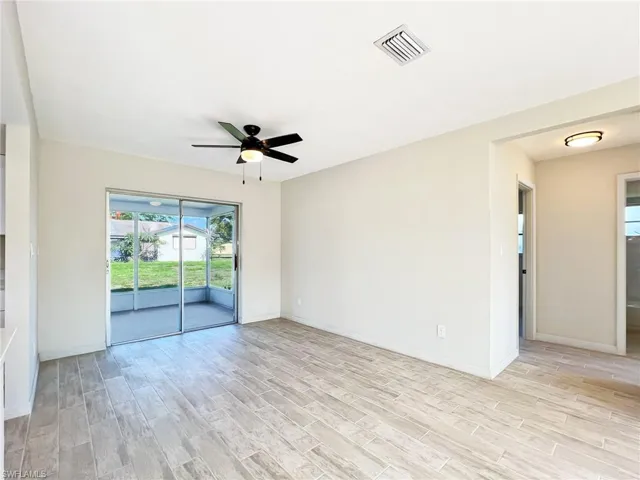 Unfurnished room with light wood-type flooring and ceiling fan