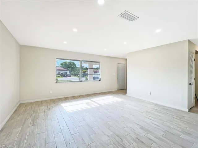 Unfurnished room with light hardwood / wood-style flooring