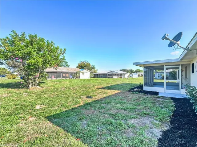 View of yard featuring a sunroom