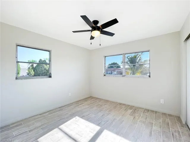 Empty room featuring ceiling fan and light wood-type flooring