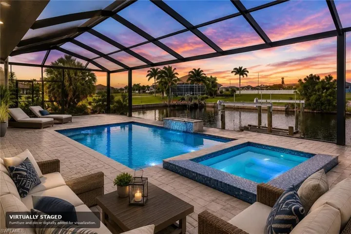 Screened lanai featuring a swimming pool, integrated spa, and canal access