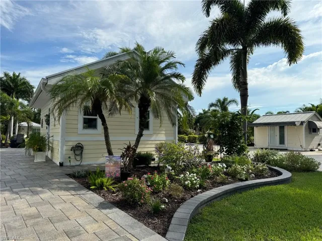 View of property exterior featuring a lawn