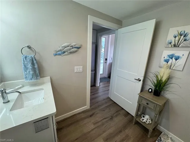 Bathroom with vanity and wood-type flooring