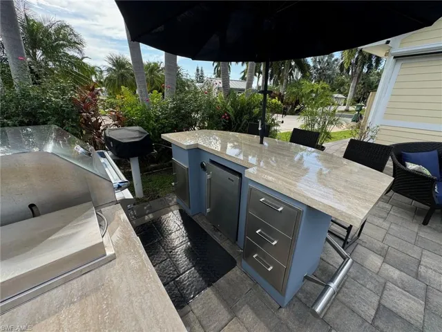 View of patio / terrace featuring area for grilling and pool water feature