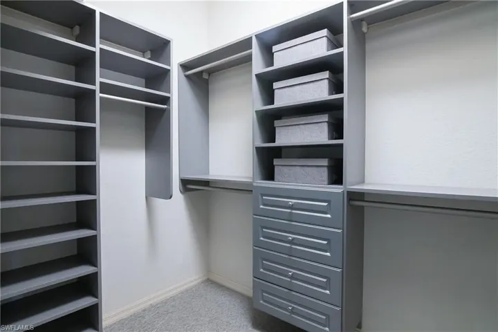 Spacious closet featuring custom built-ins