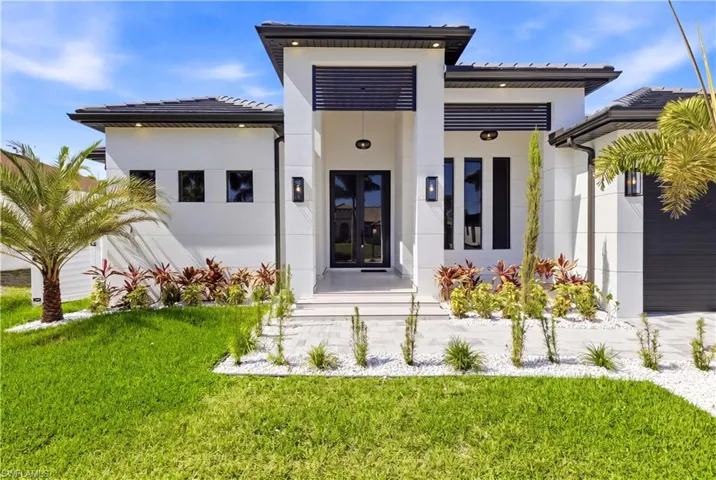 ENTER FRONT-COLUMN PORCH w/ into IMPRESSIVE FOYER w/ stylish ACOUSTIC PANELING FLOWING from the CEILING into LATERAL WALLS, complemented by 10-ft DOUBLE-FROSTED DOORS