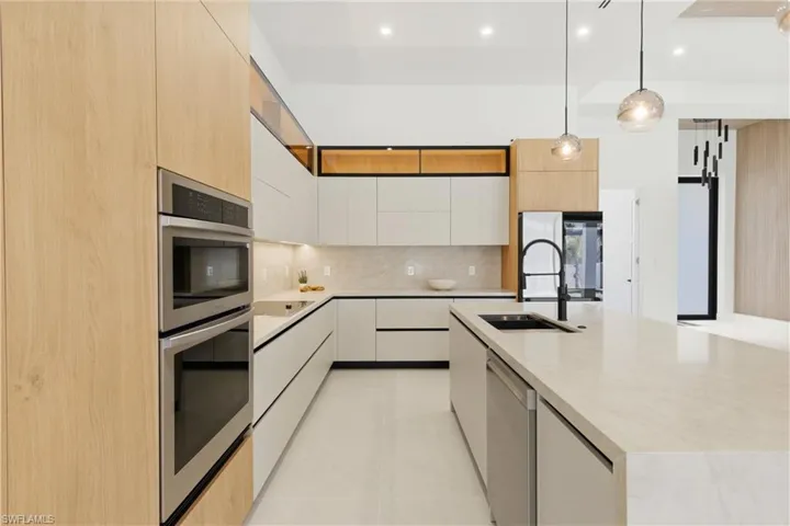 Top-of-the-line CABINETRY, under- & top-cabinet lighting, TAJ MAHAL-inspired quartz countertops, full backsplash, POT FILLER