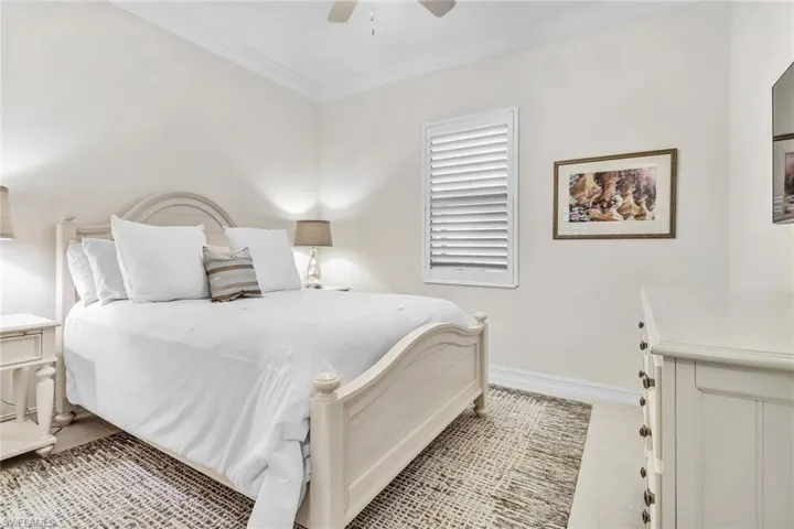 Bedroom featuring ornamental molding and ceiling fan