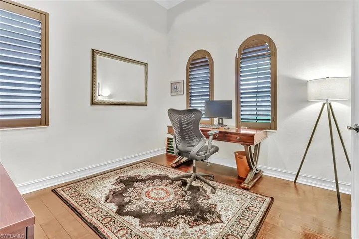 Office with hardwood / wood-style flooring