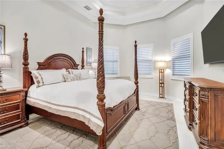 Bedroom with a high ceiling and ornamental molding
