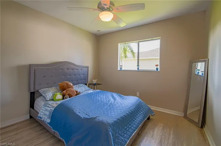 Bedroom featuring wood-type flooring and ceiling fan