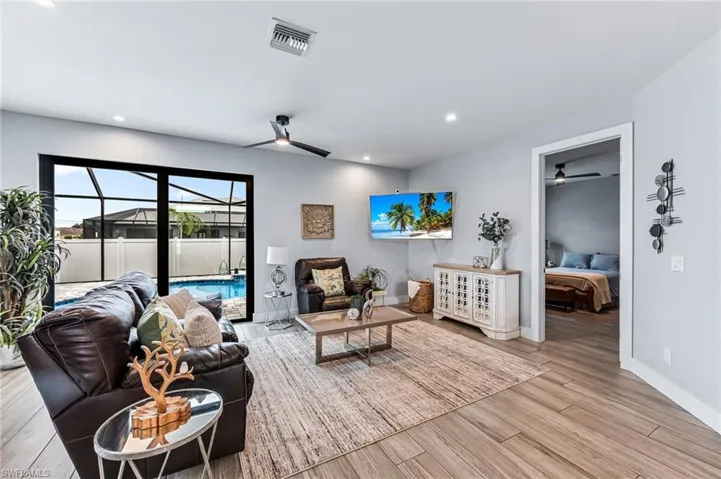 Living room with light wood-type flooring and ceiling fan