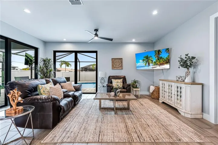Living room featuring wood-type flooring and ceiling fan