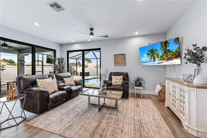 Living room featuring ceiling fan and hardwood / wood-style floors