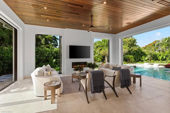 View of patio / terrace with an outdoor pool, an outdoor living space with a fireplace, and ceiling fan