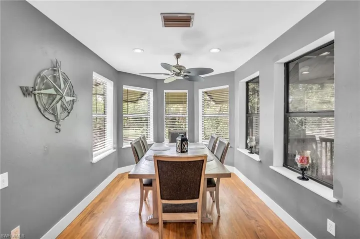 Dining area with ceiling fan and light hardwood / wood-style floors