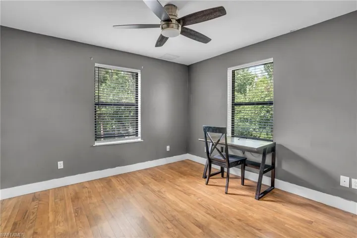 Office area featuring light wood-type flooring and ceiling fan