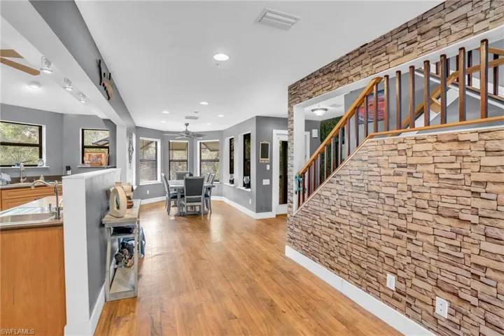 Entrance foyer featuring sink, ceiling fan, and light hardwood / wood-style floors