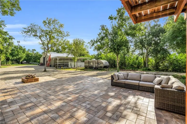 View of patio featuring an outdoor living space with a fire pit