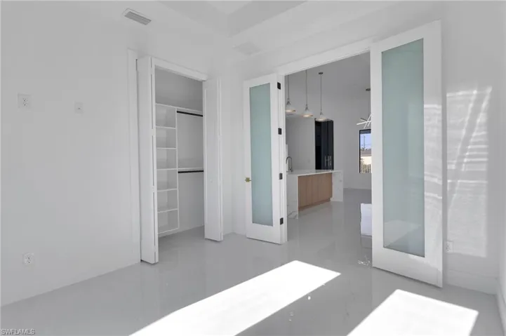 Unfurnished bedroom featuring a closet and ensuite bathroom