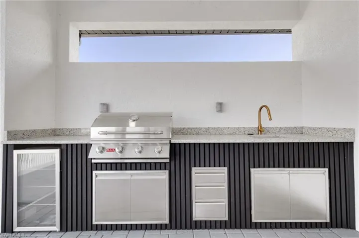 View of patio featuring exterior kitchen and wine cooler