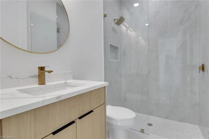 Full bathroom featuring walk in shower and vanity