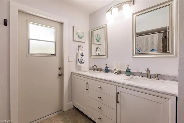 Bathroom featuring double sink vanity and tile floors