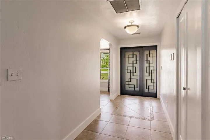 Entrance foyer with light tile floors