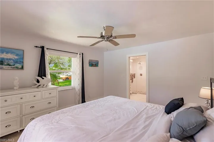 Bedroom featuring ensuite bathroom and ceiling fan