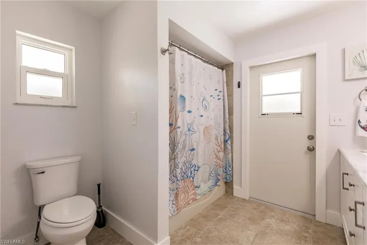 Bathroom featuring tile flooring, vanity, and toilet