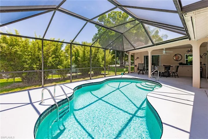 View of pool with a patio area, a lanai, and ceiling fan