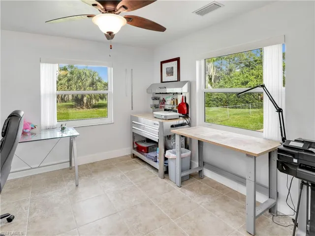 Office area featuring ceiling fan, a healthy amount of sunlight, and light tile floors