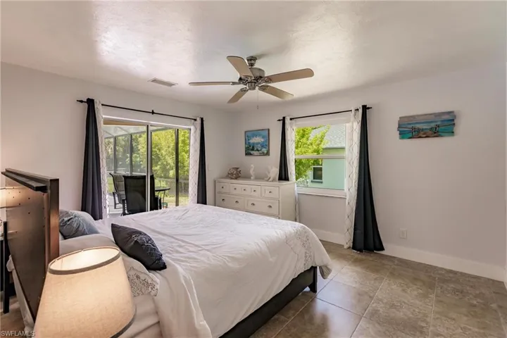 Bedroom with access to exterior, ceiling fan, and tile floors
