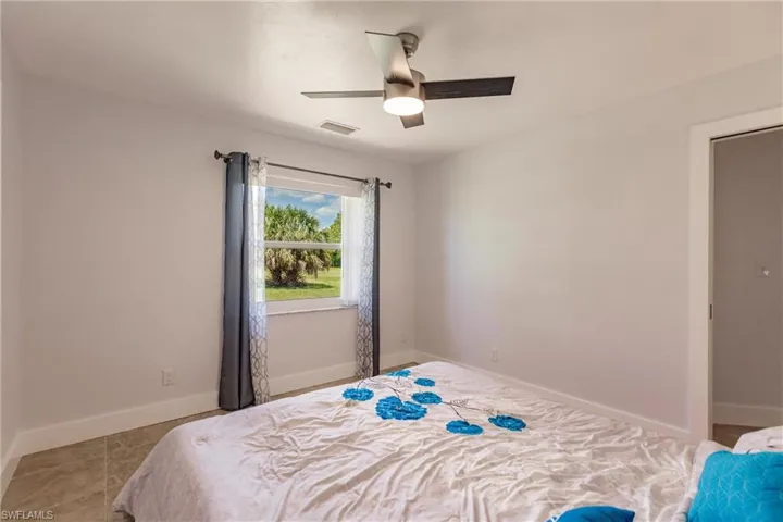 Tiled bedroom with ceiling fan