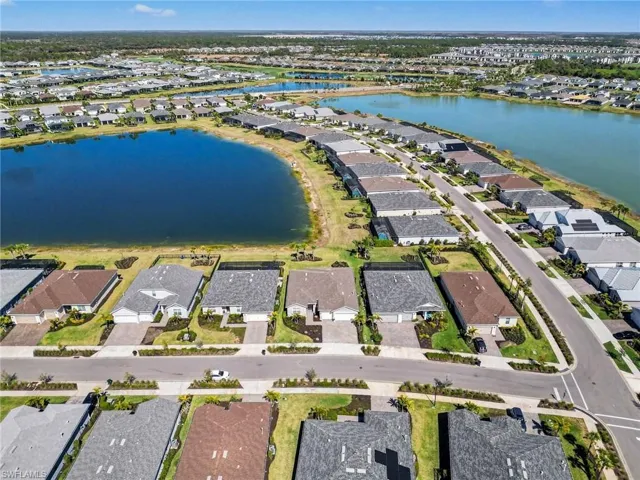 Aerial view of property's location with nearby suburban area and a large body of water