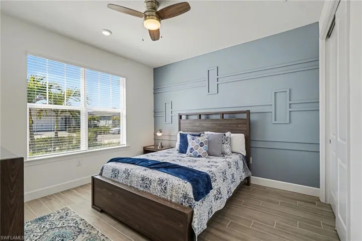 Bedroom featuring wood finish floors and a ceiling fan