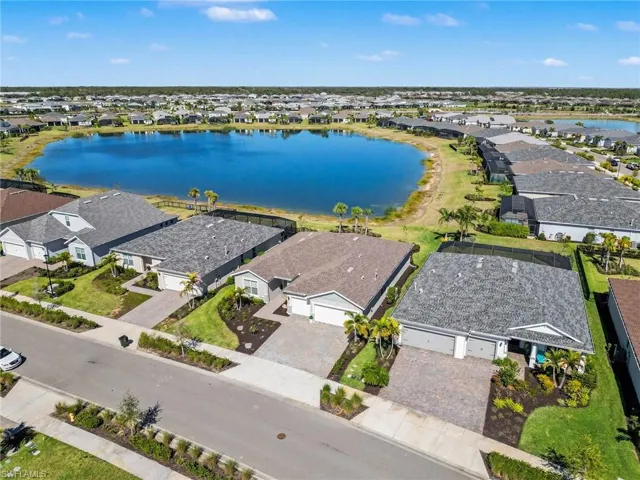 Aerial perspective of suburban area featuring a nearby body of water