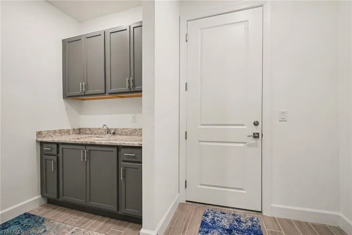 Laundry room with wood tiled floors