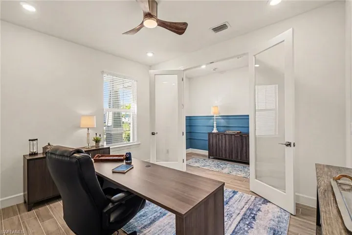 Home office featuring wood tiled floors, a ceiling fan, and recessed lighting