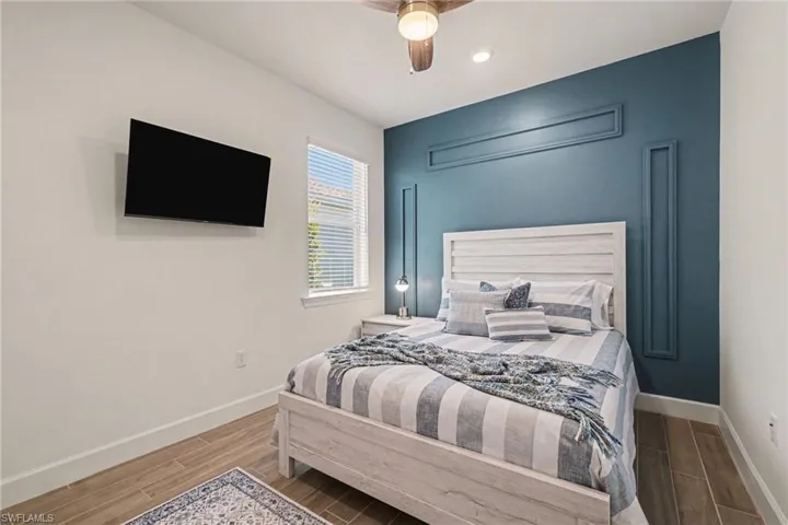 Bedroom featuring wood tiled floors and ceiling fan