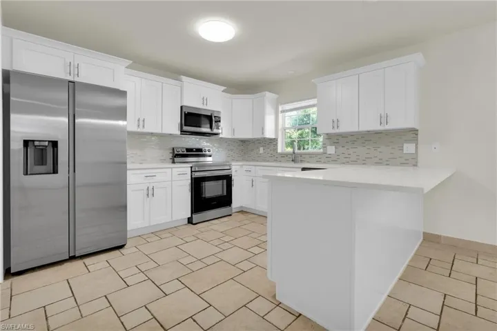 The Kitchen Comes With New Quartz Countertops (Able To Seat 3 People), New Soft Touch Closing White Wood Cabinets And Drawers, New Sink And Fixtures, New Stainless Steel Appliances, And A Tile Backsplash!