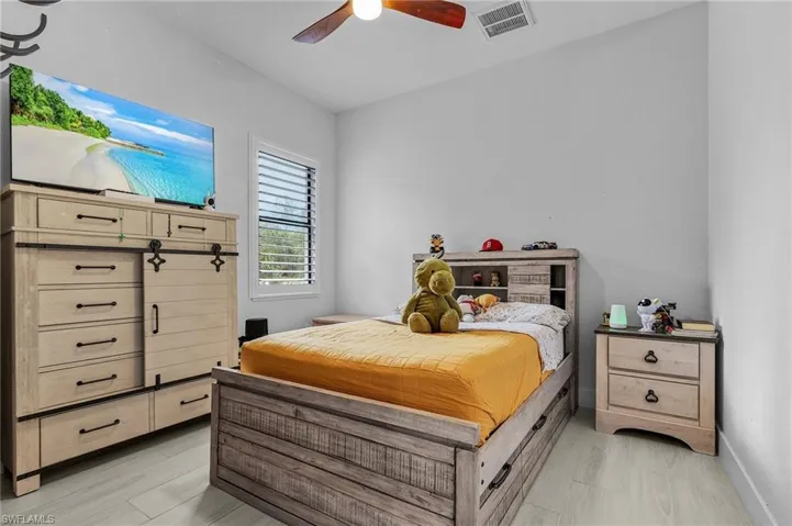 Bedroom featuring visible vents, ceiling fan, and baseboards