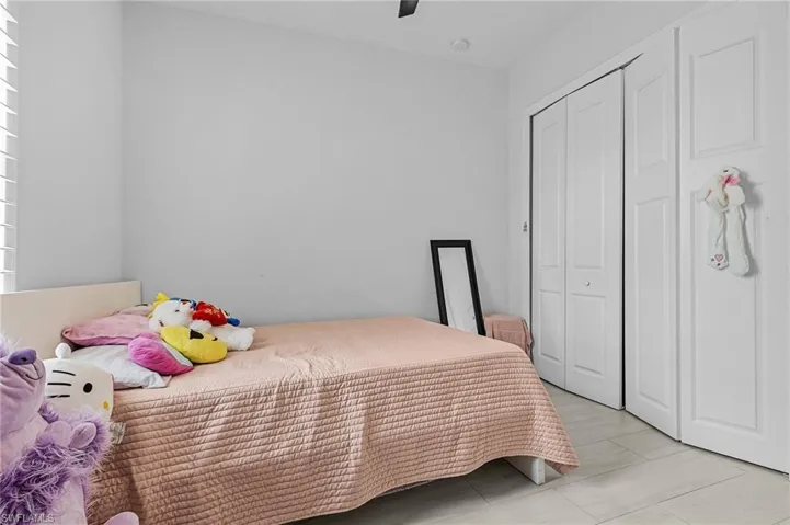 Bedroom featuring a ceiling fan and a closet