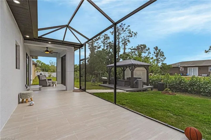 View of patio / terrace featuring ceiling fan, a gazebo, and a lanai