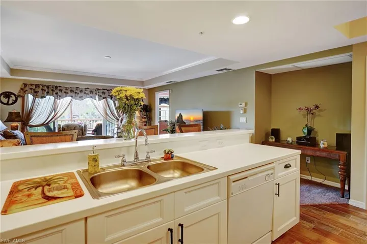 Kitchen with visible vents, dishwasher, light countertops, light wood-style floors, and a sink